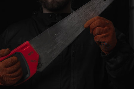 saw with a red handle in man hand isolated on white background