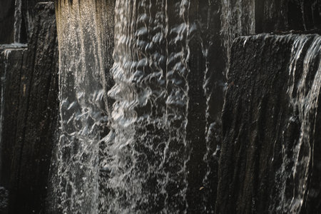 A waterfall flowing at park Wall of water A beautiful view of the falling water cascade city...