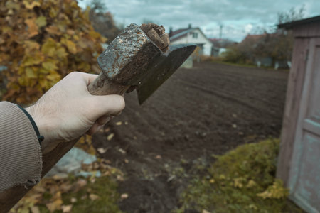 Old rusty axe with wooden handle stuck in the stump Large ax in handの写真素材