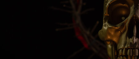 Skull of a person with crown of thorns close up on a black background