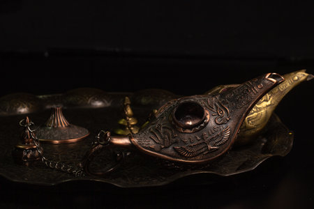 Aladdin's magic lamp isolated on black backgroundの写真素材