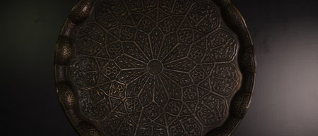 A bronze tray with geometric figures in the traditional execution of oriental cultureの写真素材