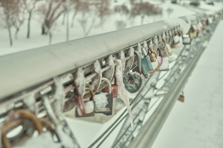Frozen padlocks are installed along the bridge path and the love locks are thrown into the river with the hope of loving bonds continue to be non-releasable Natural light selective focusの写真素材