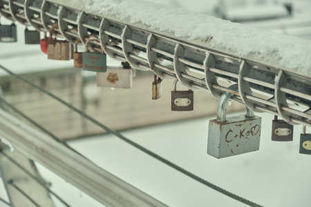 Frozen padlocks are installed along the bridge path and the love locks are thrown into the river with the hope of loving bonds continue to be non-releasable Natural light selective focusの写真素材
