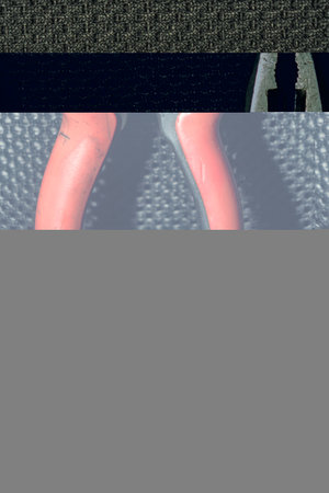 Pliers Open metal nippers with a red and green handle isolated on black backgroundの写真素材