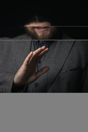 charismatic man in a classic suit and steampunk goggles on a black background stylish Portrait