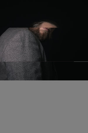 charismatic man in a classic suit and steampunk goggles on a black background stylish Portraitの写真素材