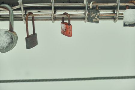 Frozen padlocks are installed along the bridge path and the love locks are thrown into the river...