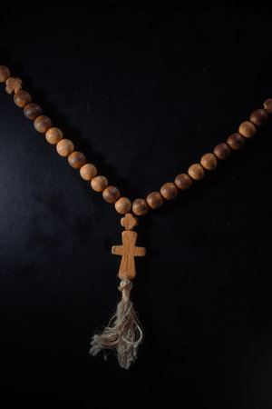 christian crucifix and rosary beads on abstract grey background. spiritual symbol of Lent. Orthodox,...