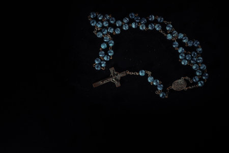 christian crucifix and rosary beads on abstract grey background. spiritual symbol of Lent. Orthodox,...