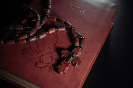 Rosary beads and crucifix cross on holy bible background