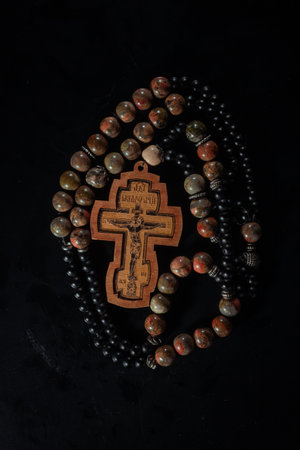 christian crucifix and rosary beads on abstract grey background. spiritual symbol of Lent. Orthodox, Catholic, Protestant religion, faith in God, Church holiday concept. flat layの写真素材