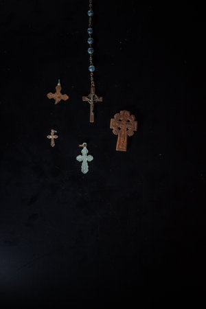 christian crucifix and rosary beads on abstract grey background. spiritual symbol of Lent. Orthodox,...