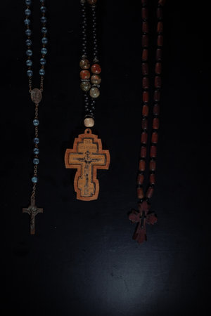 christian crucifix and rosary beads on abstract grey background. spiritual symbol of Lent. Orthodox,...