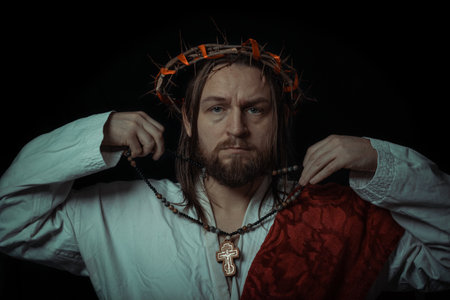 Jesus Christ wearing a crown of thorns and white chiton toga mantle cape himation suffering for mankind's sins in artistic mystical portraitの写真素材