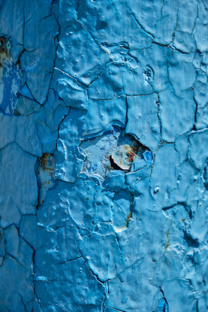 Rust on a blue surface. Cracks in the paint. Old iron. Rusty stains on metal. Background water columnの写真素材