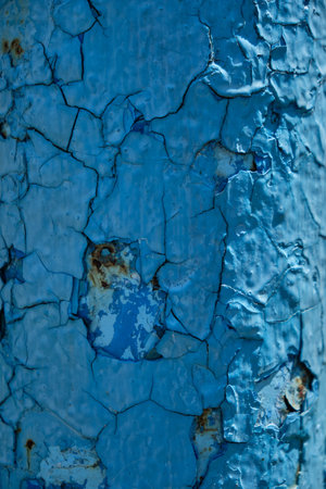 Rust on a blue surface. Cracks in the paint. Old iron. Rusty stains on metal. Background water columnの写真素材