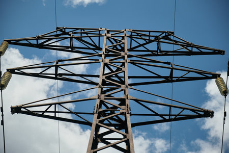 High-voltage power line, electricity pylon, power line mast against the blue sky, wires and glass insulators. Energy conceptの写真素材