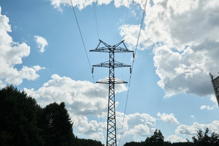 High-voltage power line, electricity pylon, power line mast against the blue sky, wires and glass...