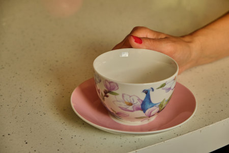 Woman pouring hot coffee in cup in the morning from pot. Housewife at home making fresh ground coffee in kitchen for breakfast, drinking, grinding coffee espresso before going to workの写真素材