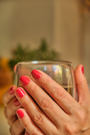 Woman pouring hot coffee in cup in the morning from pot. Housewife at home making fresh ground...