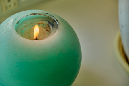 Woman holding candle in hands on casual home background, closeupの写真素材