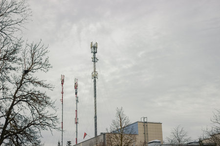 Telecommunication tower with 5G cellular network antenna on city background
