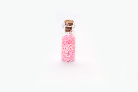 Glitter (small figurines) in small glass bottles with corksの写真素材