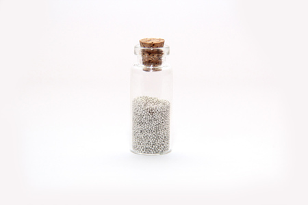 Glitter (little balls) in small glass bottlesの写真素材