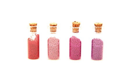 Glitter (little balls) in small glass bottlesの写真素材