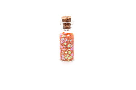 Glitter (small figurines) in small glass bottles with corksの写真素材