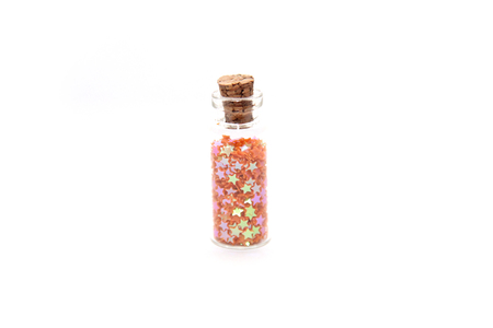 Glitter (small figurines) in small glass bottles with corksの写真素材