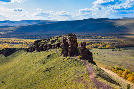 Autumn steppe landscape. Rock formation on the mountain slope. Khakassia, Siberia, Russiaの写真素材