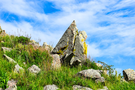 Mountain landscape with stones and grass under a blue sky with clouds. Khakassia, Siberia, Russia,...