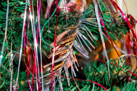 Christmas tree decorated with tinsel and garlands, close-upの写真素材