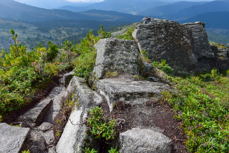 rocky trail in the mountains in summer with blue sky and white clouds. Ergaki, Krasnoyarsk...
