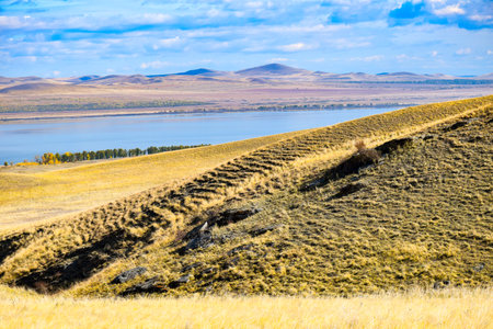 Autumn steppe. Yellow grass on the shores of the lake. Khakassia, Siberia, Russiaの写真素材