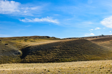 Hills in the steppe against the blue sky with clouds. Khakassia, Siberia, Russiaの写真素材