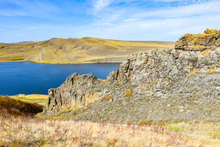 Mountain landscape with dry grass and blue sky with white clouds. Khakassia, Siberia, Russia, Sahsyrの写真素材