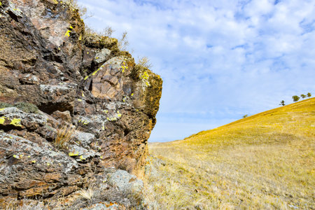 Rocky hillside and blue sky with white clouds. Khakassia, Siberia, Russia, Sahsyrの写真素材