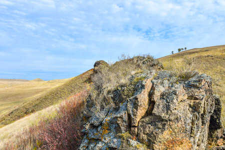Rocky hillside under blue sky with white clouds. Khakassia, Siberia, Russia, Sahsyrの写真素材
