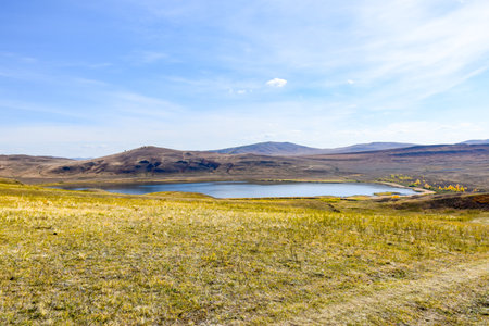 Beautiful autumn landscape in the steppe. Yellow grass and blue sky. Khakassia, Siberia, Russia, Sahsyrの写真素材