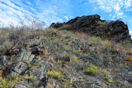 Dry grass on the slope of the mountain against the blue sky. Khakassia, Siberia, Russiaの写真素材