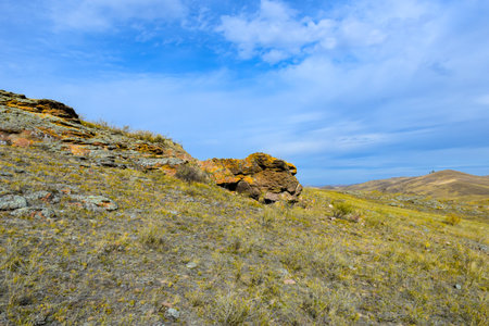 Mountain landscape in the steppe against the blue sky with clouds. Khakassia, Siberia, Russiaの写真素材