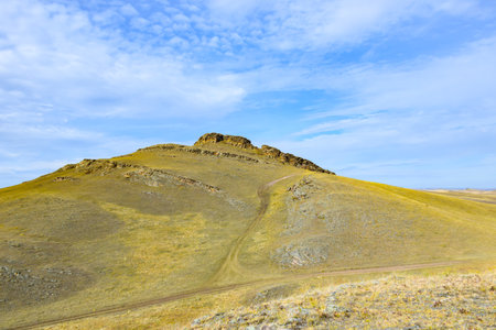 Mountain landscape in the steppe against the blue sky with clouds. Khakassia, Siberia, Russiaの写真素材