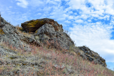 Rocky slope of a mountain against the blue sky with clouds. Khakassia, Siberia, Russiaの写真素材