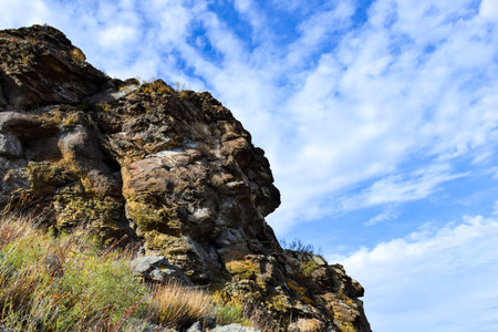 Rocky cliff in the blue sky with white clouds, natural background. Khakassia, Siberia, Russiaの写真素材