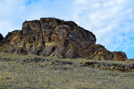 Rocky hills in the steppe against the blue sky with clouds. Khakassia, Siberia, Russiaの写真素材