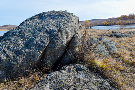 Rocks on the shore of the lake. Early spring in the steppe. Khakassia, Siberia, Russia