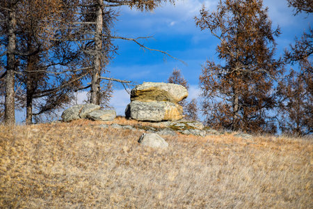 rocky hillside in autumn with dry grass and blue sky in background. Khakassia, Siberia, Russiaの写真素材